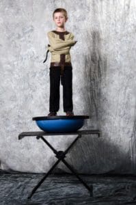 A man standing on top of a blue bowl.
