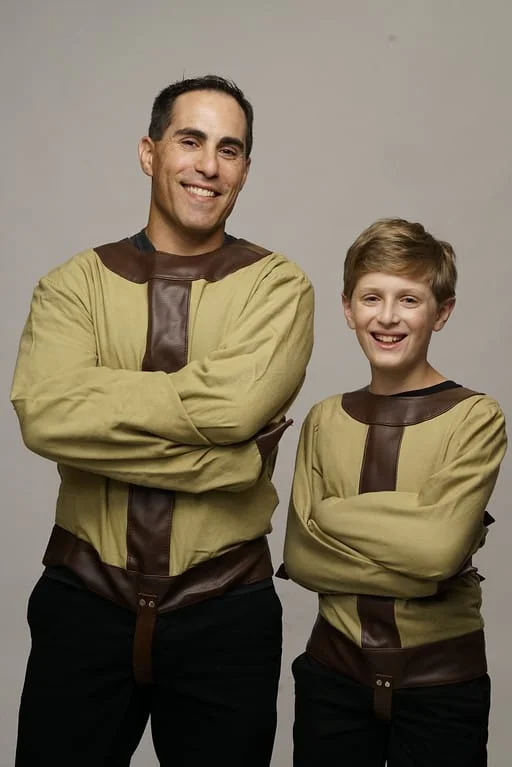 Two people standing next to each other wearing costumes.