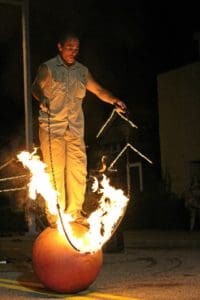 A man standing on top of a fire ball.