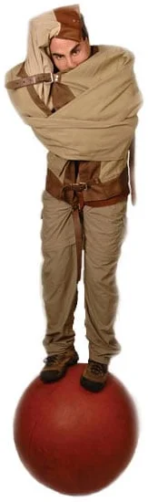 A man wearing brown pants and a tan shirt.